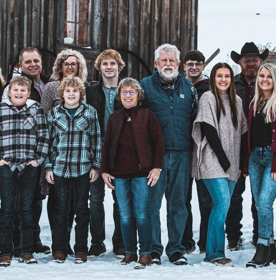 Three generations of a family standing together outdoors